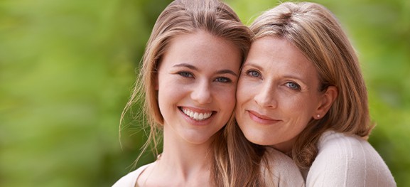 a young woman and a mature woman smiling