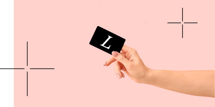 An arm holding a card with a white Lumenis logo representing Lumenis+ Membership Rewards